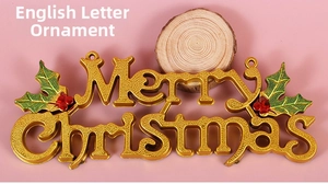 Close-up of golden Merry Christmas sign with textured letters and holly berry details
