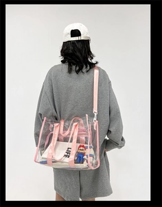 Detailed back view of a transparent PVC shoulder bag with pink straps and Life inner pouch