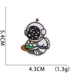 Detailed macro of embroidered astronaut patch with dimensions 5.4cm height and 4.3cm width