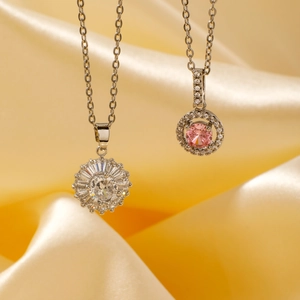 Luxurious silver geometric necklace with pink zircon pendant on gold silk background