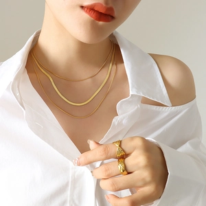 Elegant gold layered snake chain necklace set with quilted band and bow rings