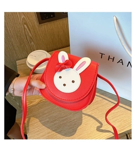 Detailed view of kids red bunny shoulder bag with white rabbit ears and a bow
