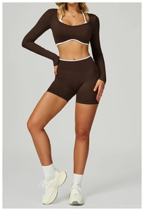 Detail of slim fit yoga crop top with contrast white piping and matching high waist shorts