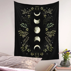 Detail of moon phase wall tapestry with botanical design hanging in a cozy bedroom