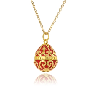 Red Faberge style egg necklace with gold scrollwork and Greek inscription