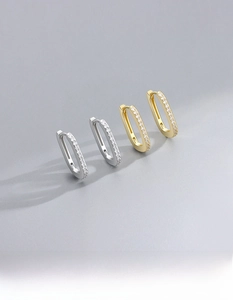 Detailed macro view of S925 sterling silver rectangular hoop earrings in gold and silver