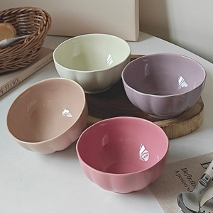 Detailed view of pumpkin-shaped ceramic bowls in pastel pink, purple, and green colors