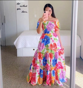Détail d'une robe maxi fleurie à épaules dénudées avec bustier froncé et ourlet large