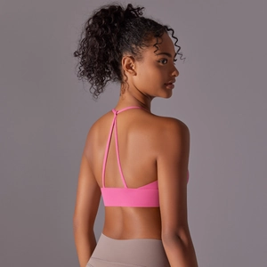 Detail view of the Y-shaped back straps and elastic band of the pink yoga sports bra