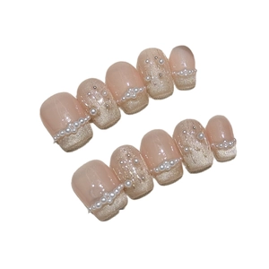 Handmade press-on nails with bow, pearls and champagne gold glitter in French style