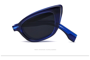 Detail view of foldable dark blue cat-eye sunglasses with modern geometric design