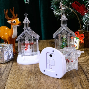 Lighted Christmas church snow globe with snowman miniature and glowing holiday scene