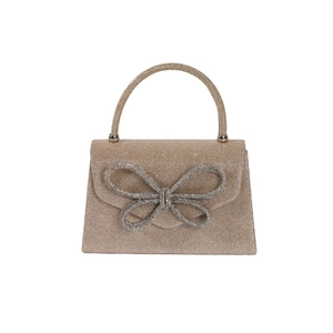 Sparkling gold evening clutch bag with rhinestone bow detail and top handle on white background