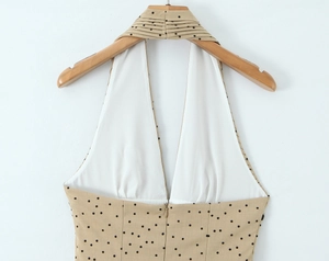 Detail of khakhi polka dot halter dress featuring a seamless invisible back zipper closure