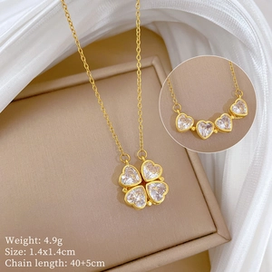 Detail view of a gold clover necklace with crystal inlay and technical product dimensions