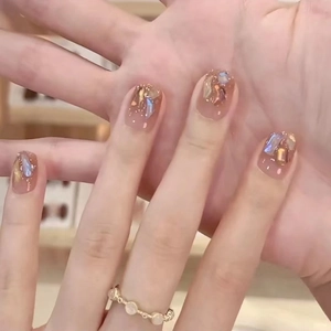 Handmade Maillard press-on nails with gold foil and iridescent shell flakes
