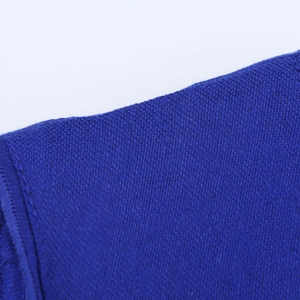 Close-up of blue linen-textured fabric showing detailed woven fibers of the dress