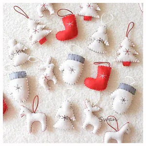 Flat lay of handmade felt Christmas ornaments including boots, angels, and horses