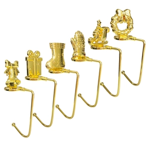 Detailed view of six golden Christmas stocking hooks featuring snowflake and Santa designs