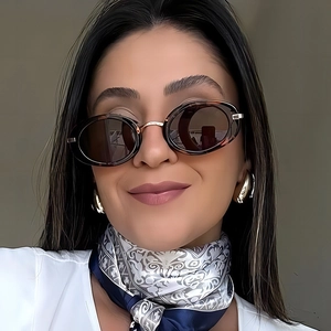 Vintage oval tortoiseshell sunglasses for women with brown lenses and metal bridge