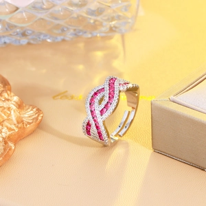 Macro detail of crisscross ring featuring red rubies and brilliant white zircons
