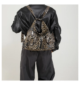 Detailed view of trendy leopard print backpack showing fabric texture on a model