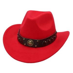 Detailed view of red felt cowboy hat with leather band and brass horseshoe emblem
