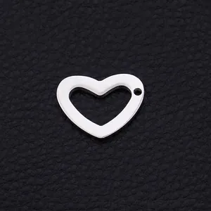 Minimalist stainless steel heart pendant with cutout design on black leather surface