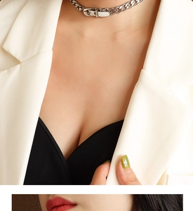 Close-up of a silver buckle NK chain necklace styled with a white blazer for women