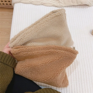 Detail of soft fleece makeup bags in cream and camel colors with zipper closure