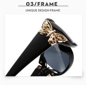 Macro detail of golden butterfly hinge on black rectangular fashion sunglasses frame