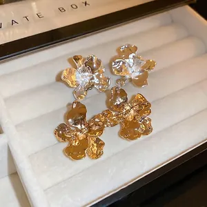Elegant gold and silver orchid flower stud earrings with textured metallic petals