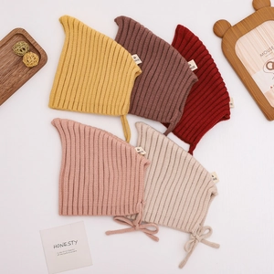 Five-pack set of knitted baby earflap hats in various solid colors with chin straps
