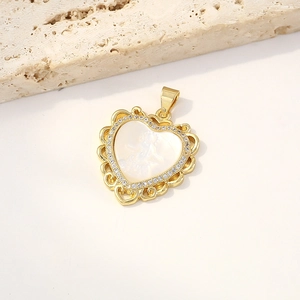 Gold heart shell pendant with mother-of-pearl relief and zircon crystals on stone