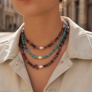 Close-up of triple-layer bohemian necklace with amethyst chips and baroque pearls