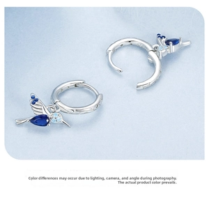 Detail view of S925 sterling silver hummingbird earrings with blue opal stones