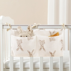 Detail of cotton baby crib organizer with two pockets and watercolor rabbit print