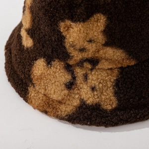 Deep brown lamb wool bucket hat featuring cute teddy bear patterns for winter warmth