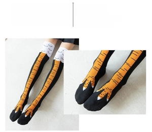 Detail of creative chicken feet over-knee socks with vibrant orange claw pattern