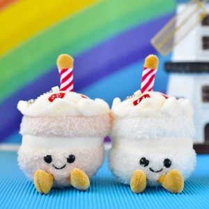 Cute plush cake pendant toys with happy faces and colorful rainbow background