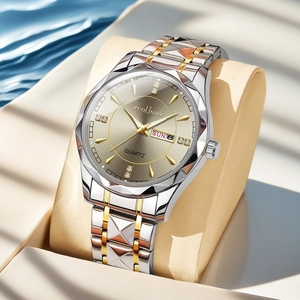 Macro detail of men's watch featuring a champagne dial with diamond indices and date window