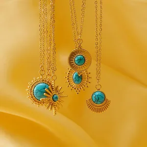 Vintage golden sun pendant necklace with turquoise stone on elegant silk fabric