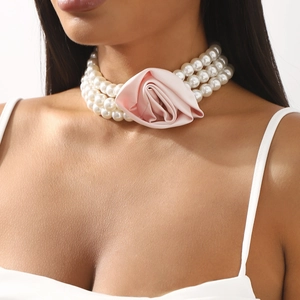 Three-layer faux pearl choker featuring a pink satin rose for elegant party styles