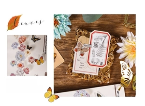 Detail of vintage butterfly and leaf stickers for scrapbooking on a rustic wood background