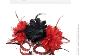 Close-up of Day of the Dead mask with red fabric flowers and black feathers detail