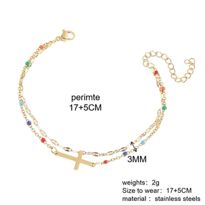 Detailed view of dual-layer gold stainless steel bracelet with cross and colorful beads