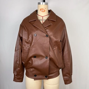 Detail of brown faux leather jacket with double-breasted buttons and notched lapel