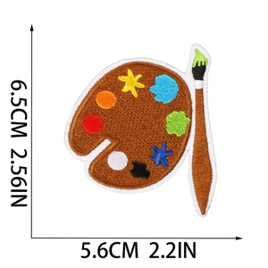 Detail view of palette embroidery patch with colorful paints and brush texture