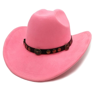 Detail of pink suede cowboy hat with brown leather band and bull head metal studs