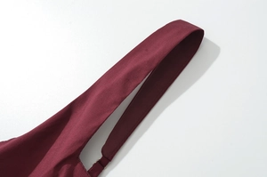 Detailed close-up of wine red fabric straps with adjustable metal buckles and stitching
